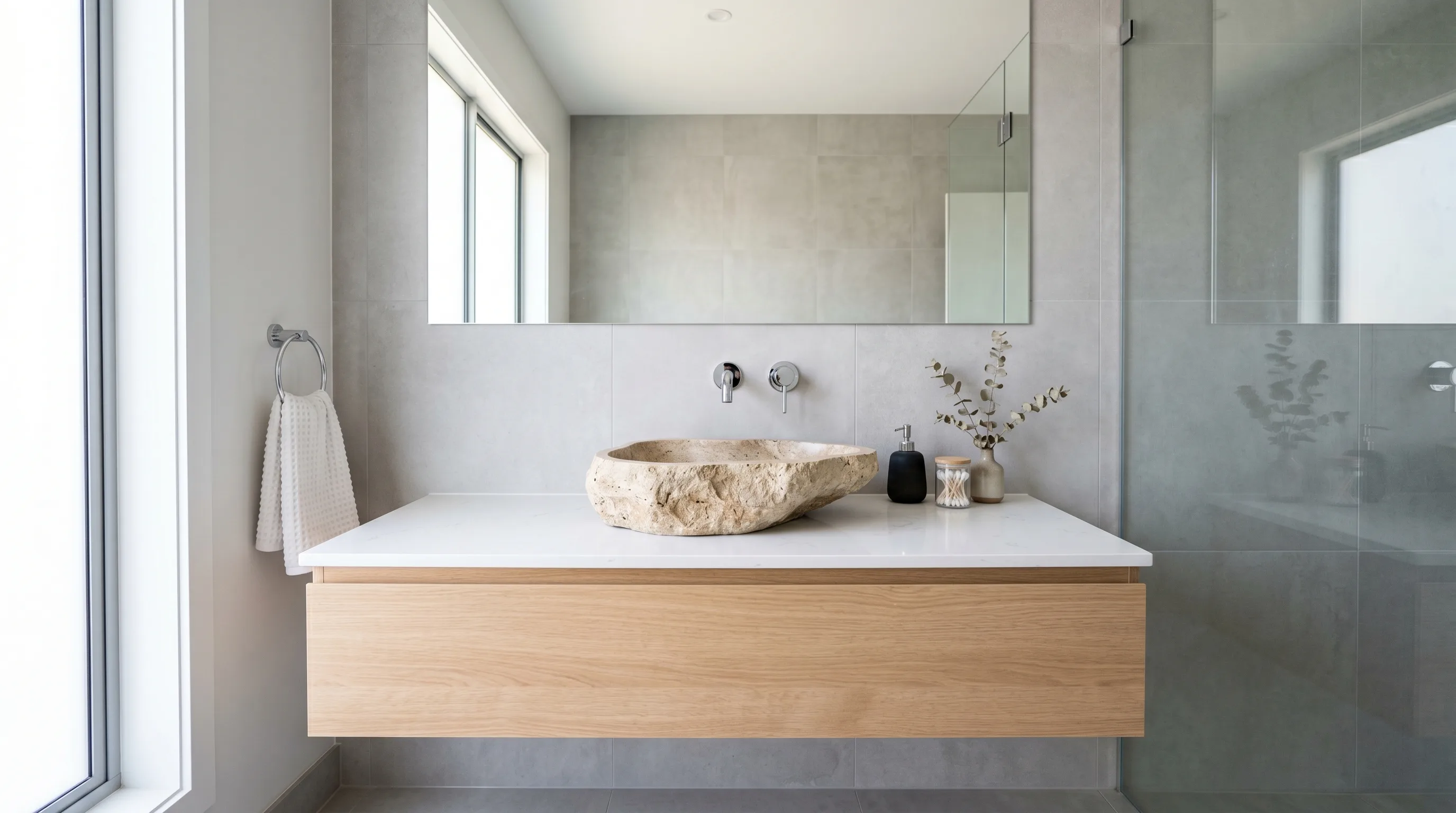 Aged metal faucet with a sculptural stone basin.